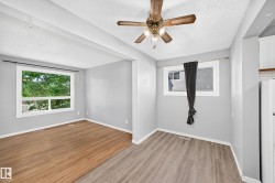 Open-concept room featuring two distinct flooring types: wood-finish and plank-style - 