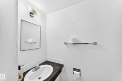 Integrated vanity with a dark countertop and white oval sink - 