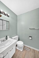 Bathroom featuring a white vanity with an integrated sink, chrome faucet, and under-sink cabinetry - 