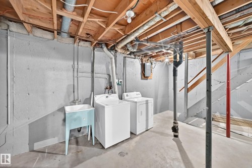 Utility space featuring a concrete floor, painted concrete block walls, and an exposed wood joist ceiling - 355 Northgate Terrace, Edmonton, AB 