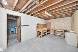 Unfinished basement offering exposed wood ceiling joists and concrete flooring - 