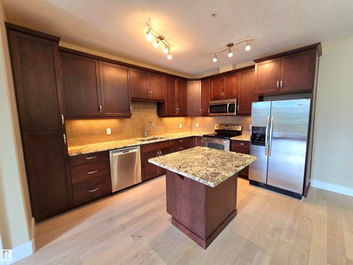 256 6079 Maynard Way, Edmonton, AB - Indoor Photo Showing Kitchen With Stainless Steel Kitchen