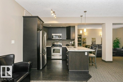 256 6079 Maynard Way, Edmonton, AB - Indoor Photo Showing Kitchen With Stainless Steel Kitchen