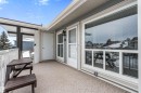 Outdoor balcony featuring a covered portion and exterior wall lighting - 2324 151 Avenue Nw, Edmonton, AB 