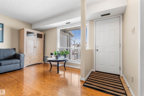 Warm wood-finish flooring complements the neutral wall tones - 2324 151 Avenue Nw, Edmonton, AB 