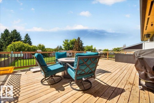 Expansive wood deck with dark metal railings and a built-in privacy screen - 5215 50 Avenue, Bruderheim, AB - Outdoor With Deck Patio Veranda With Exterior