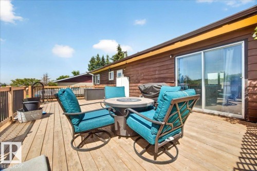 Spacious wood-finish deck with a wood railing and a sliding glass door entry to the interior - 5215 50 Avenue, Bruderheim, AB - Outdoor With Deck Patio Veranda With Exterior