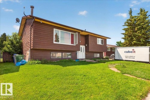 Split-level residence featuring brown horizontal siding and white trim - 5215 50 Avenue, Bruderheim, AB - Outdoor