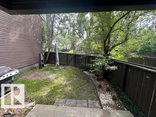 Private outdoor area featuring a partial paver patio leading to a grassy lawn - 18020 96 Avenue, Edmonton, AB 