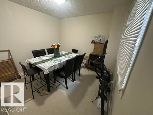 Carpeted room with a ceiling-mounted light fixture and a window featuring horizontal blinds - 18020 96 Avenue, Edmonton, AB 