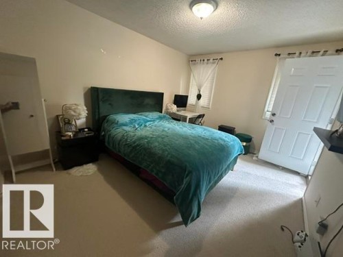 Carpeted room with a wall-mounted flush light fixture - 18020 96 Avenue, Edmonton, AB 