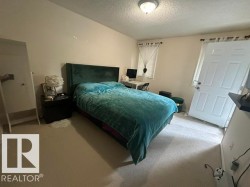 Carpeted room with a wall-mounted flush light fixture - 