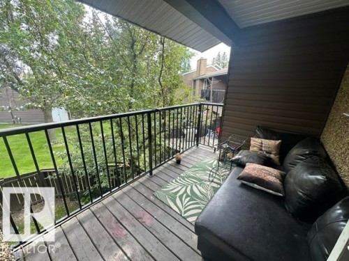 Private outdoor balcony featuring wood decking and a black metal railing - 18020 96 Avenue, Edmonton, AB 