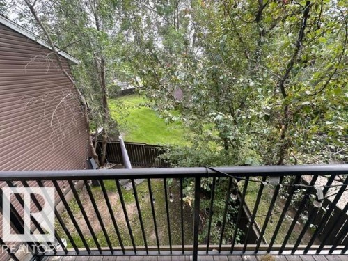 Balcony featuring dark metal railings and wood-finish flooring - 18020 96 Avenue, Edmonton, AB 