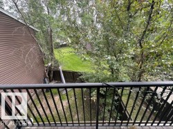 Balcony featuring dark metal railings and wood-finish flooring - 