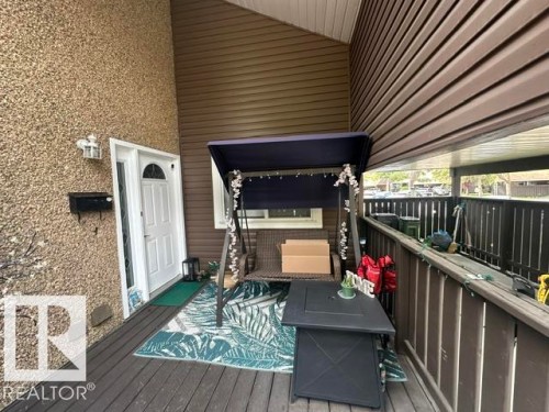 Covered outdoor deck with brown composite decking - 18020 96 Avenue, Edmonton, AB 