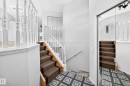 Staircase featuring white balusters and brown carpeted treads - 13124 36 Street, Edmonton, AB 
