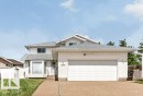 Two-story residence featuring white siding and a light gray shingle roof - 16524 99 Street, Edmonton, AB 