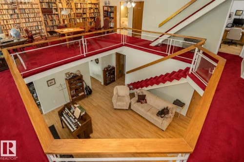 Multi-level interior featuring a spacious lower living area with wood-finish flooring - 60528 Range Road 112, Rural St. Paul County, AB 