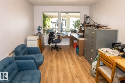 Room featuring wood-finish flooring and white painted walls - 