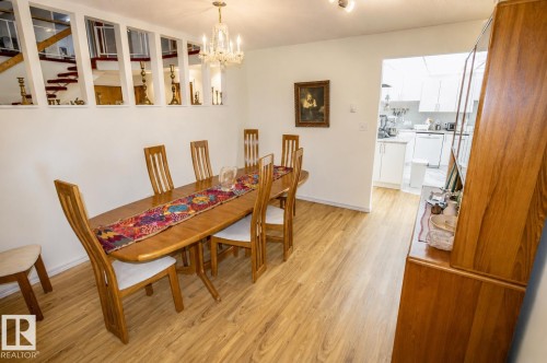 Dining area featuring light wood-finish flooring and a crystal chandelier - 60528 Range Road 112, Rural St. Paul County, AB 