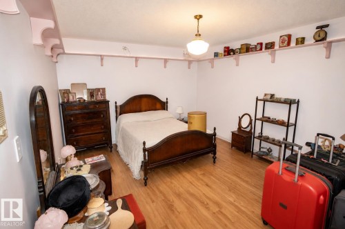 Spacious room featuring wood-finish flooring and a ceiling-mounted light fixture - 60528 Range Road 112, Rural St. Paul County, AB 
