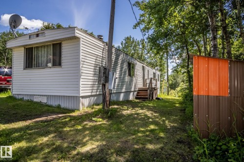 White horizontal siding with a multi-paned window - 60528 Range Road 112, Rural St. Paul County, AB 