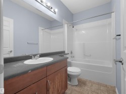 Bathroom with a full-size vanity, integrated sink, and dark countertop - 