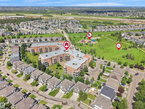 Aerial view of a multi-story residential building featuring brick and stucco exterior finishes - 106 263 Macewan Road, Edmonton, AB 