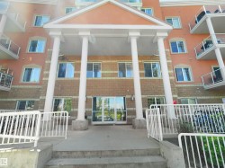 Building exterior featuring a covered portico entrance with four white columns - 
