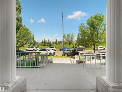 Concrete entrance with white balusters and fluted architectural columns - 106 263 Macewan Road, Edmonton, AB 