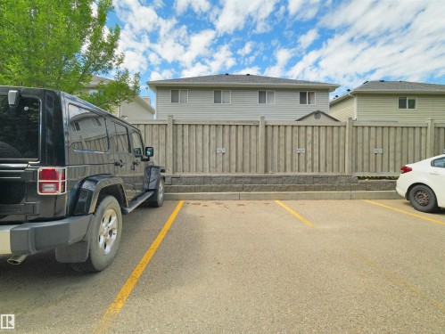 Paved parking area featuring designated parking stalls - 106 263 Macewan Road, Edmonton, AB 