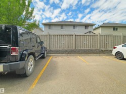 Paved parking area featuring designated parking stalls - 