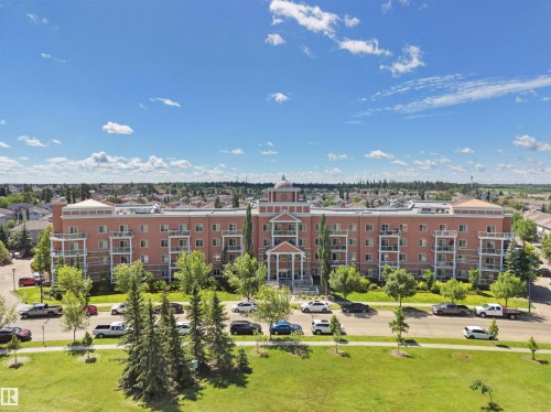 Multi-story residential building with a brick exterior and multiple private balconies - 106 263 Macewan Road, Edmonton, AB 