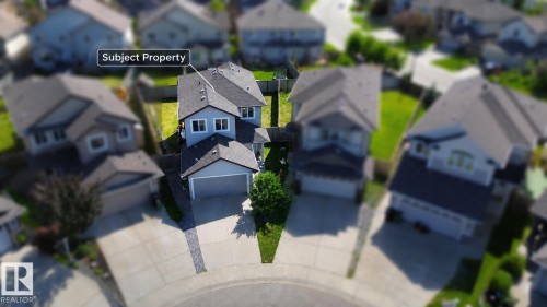 Two-story residence featuring a shingled roof, light gray siding, and an attached two-car garage - 526 173A Street, Edmonton, AB 
