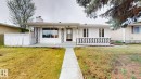 Mid-century modern facade with contrasting black and white decorative paneling, a covered front entry, and a concrete walkway - 12812 45 Street, Edmonton, AB  - Outdoor 