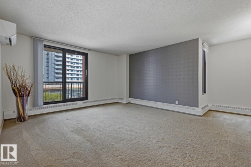 Spacious room featuring carpet flooring and white walls - 505 10145 109 Street, Edmonton, AB 