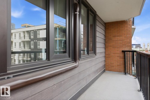 Private balcony featuring a concrete floor and black metal railings - 505 10145 109 Street, Edmonton, AB 