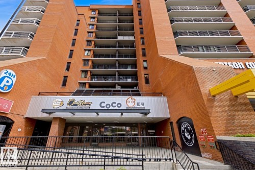 Multi-story brick building facade with multiple balconies and a ground-level commercial entrance - 505 10145 109 Street, Edmonton, AB 