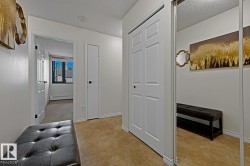 Entryway featuring light neutral walls and light brown carpeted flooring - 
