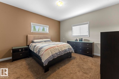 Carpeted interior space featuring two windows with white blinds - 35 Falcon Road, Cold Lake, AB 