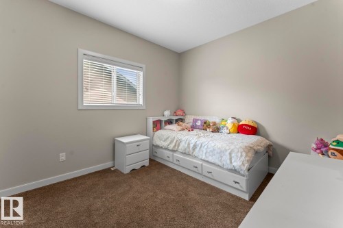 Bedroom featuring neutral wall paint, white trim, and brown carpet flooring - 35 Falcon Road, Cold Lake, AB 