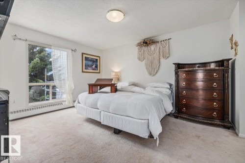 Spacious room featuring light-colored carpeting, a large window, and light-toned walls - 427 15499 Castle Downs Road, Edmonton, AB 