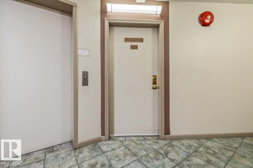 "Guest Suite" entry door with brass hardware, accented by brown trim - 427 15499 Castle Downs Road, Edmonton, AB 