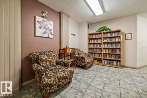 Tiled flooring with a neutral pattern, illuminated by a ceiling-mounted fluorescent light fixture - 427 15499 Castle Downs Road, Edmonton, AB 