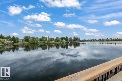 Expansive lake offering clear reflections of the blue sky and clouds - 427 15499 Castle Downs Road, Edmonton, AB 
