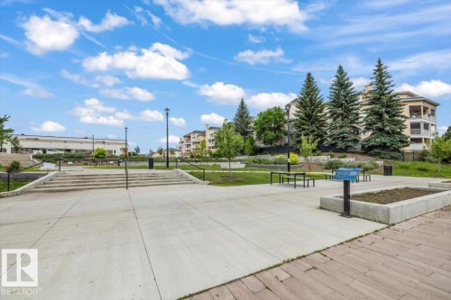 Expansive concrete plaza featuring integrated steps and a raised planting bed - 427 15499 Castle Downs Road, Edmonton, AB 