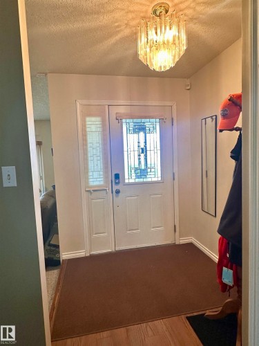 Entryway featuring a decorative frosted glass front door and coordinating sidelight - 10619 108 Avenue, Westlock, AB - Indoor Photo Showing Other Room