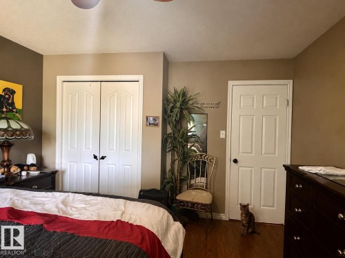 Bedroom featuring wood-finish flooring, a ceiling fan, and painted walls - 10619 108 Avenue, Westlock, AB - Indoor Photo Showing Bedroom