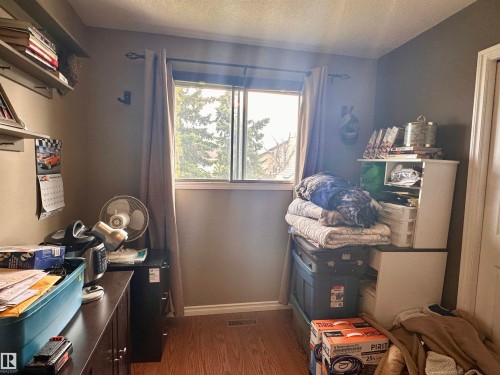 Window featuring neutral curtains and a decorative rod - 10619 108 Avenue, Westlock, AB - Indoor